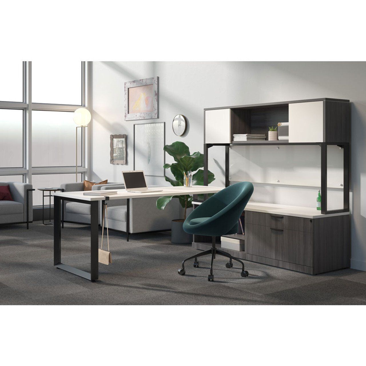 an office with a couch, a desk with a laptop on it and blue desk chair