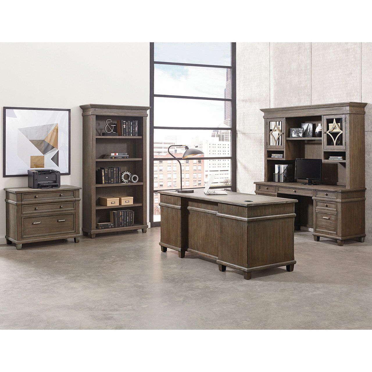 a room with a desk a bookcase and a printer