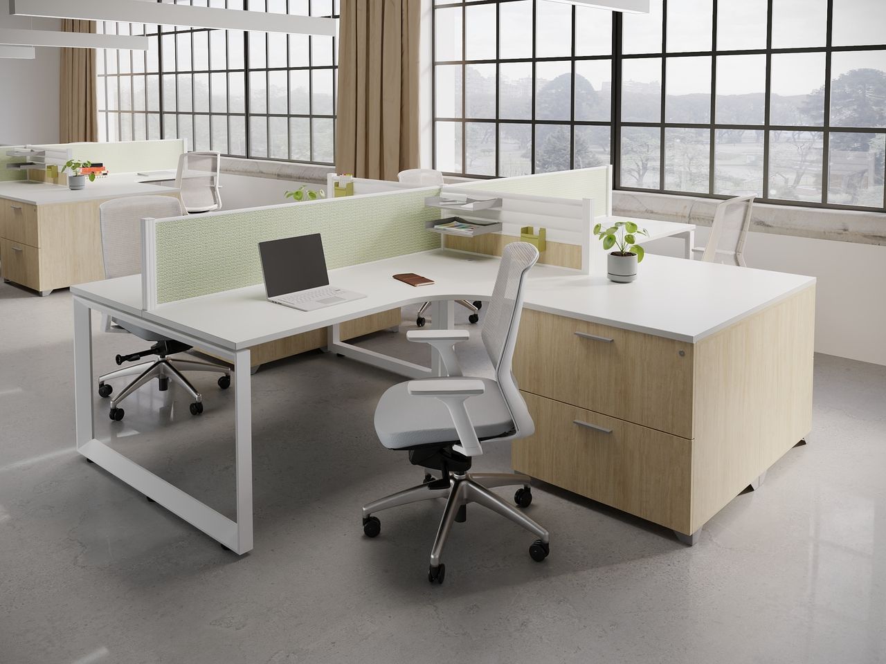Modern office cubicle with white and wood desks, white chairs, and a green divider.