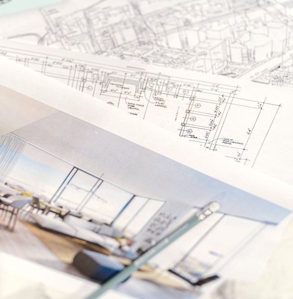 stack of papers with space plans and rendering of a room