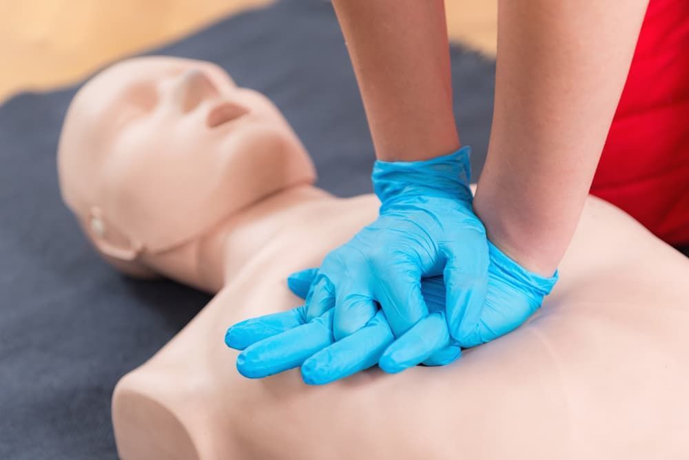 Hands Performing Chest Compressions on a CPR Training Mannequin —Revive Training in Byron Bay, NSW