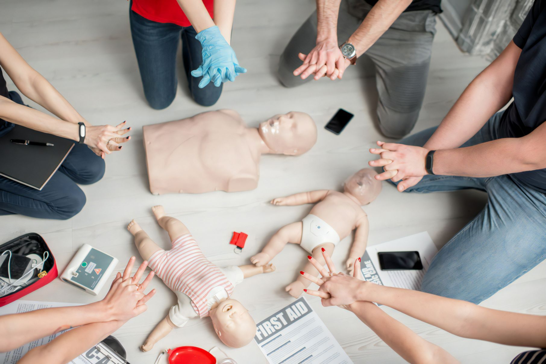 Group Of People Learning How To Make First Aid Heart Compressions With Dummies — Revive Training in Alstonville, NSW
