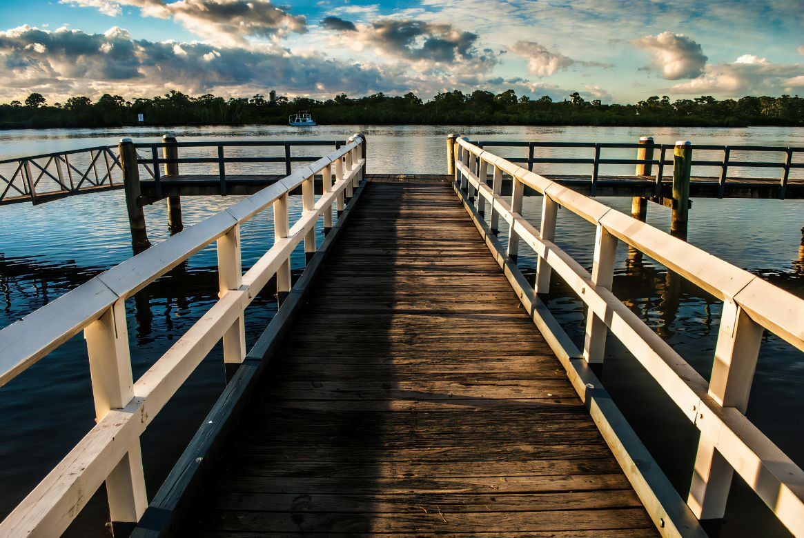 A Wooden Pier Leading Into a Body of Water — Revive Training in Tweed Heads, NSW