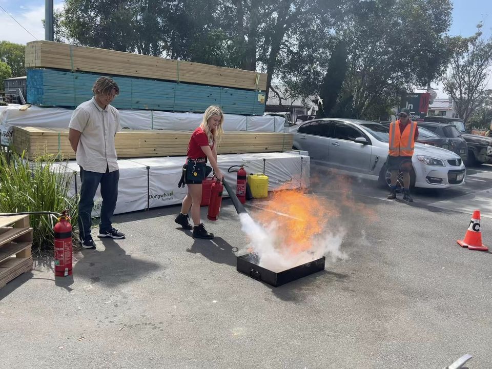 Man Holding The Fire Extinguisher — Revive Training in Alstonville, NSW
