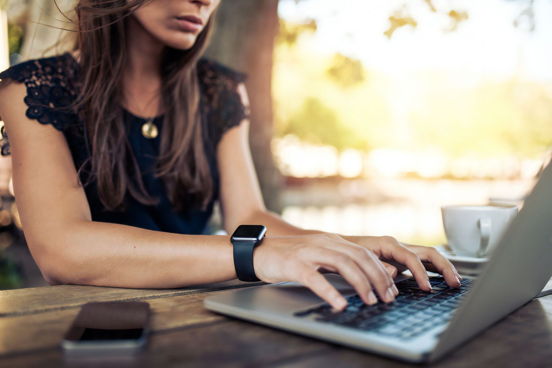 Person Typing on a Laptop at an Outdoor Table — Revive Training in Alstonville, NSW