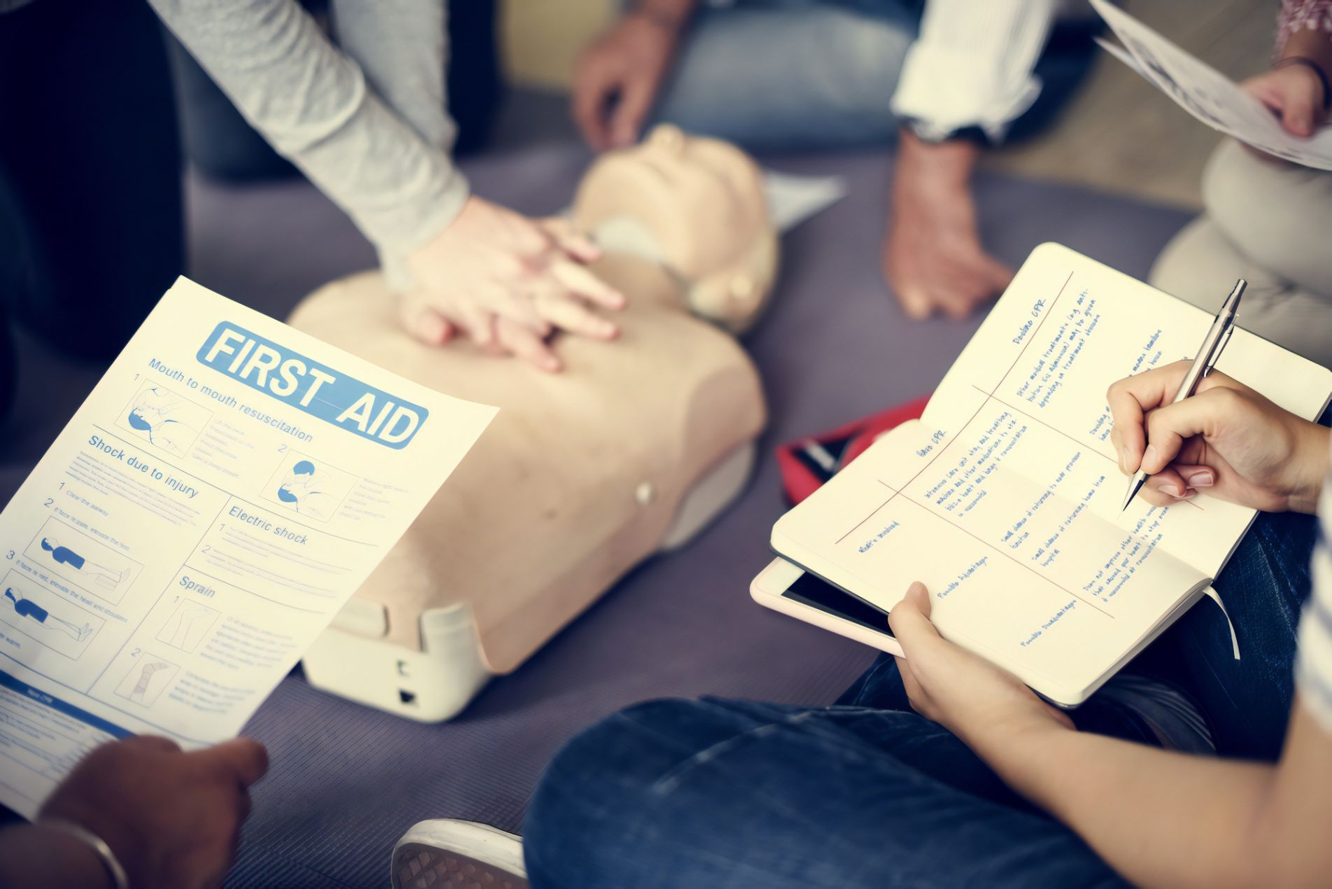 People Practicing CPR on a Training Mannequin With a Checklist Nearby — Revive Training in Alstonville, NSW