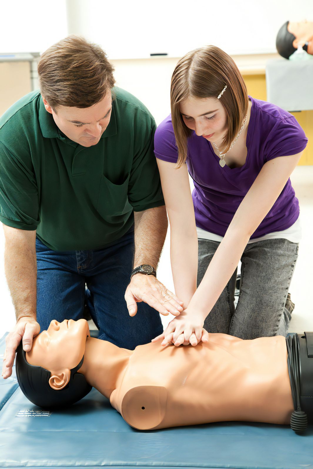 Instructor Teaching Girl A CPR On Mannequin — Revive Training in Lismore, NSW
