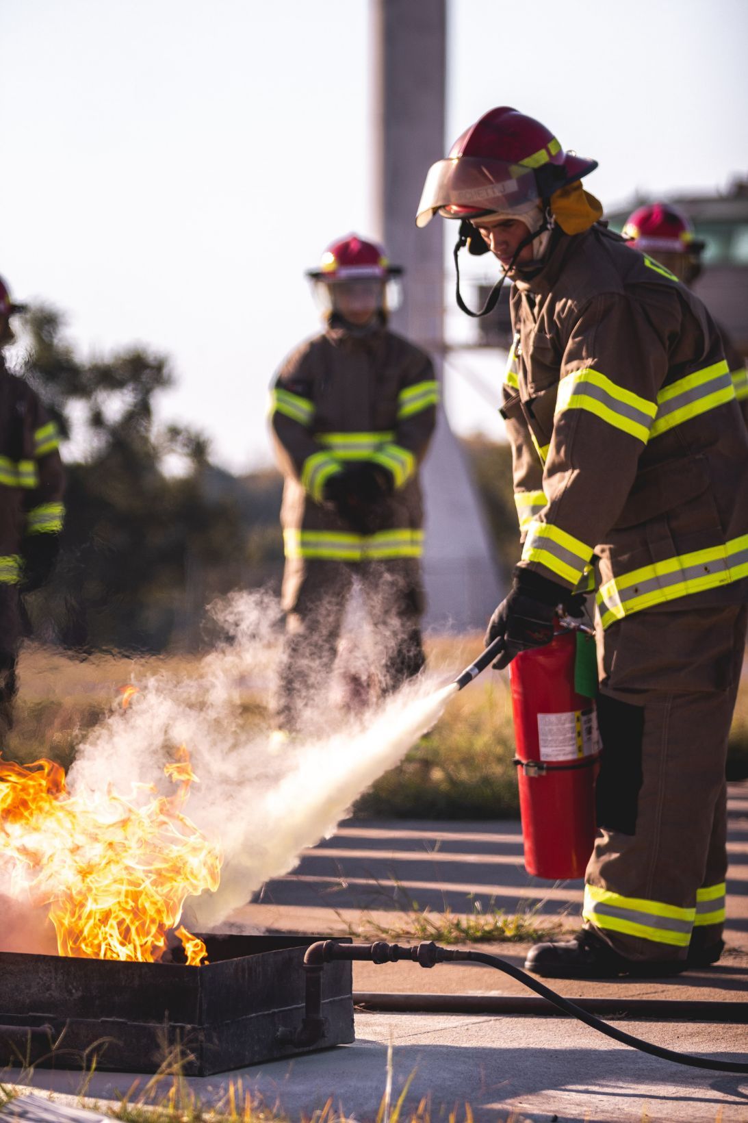 Firefighters in Gear Extinguish a Blaze With a Hose Outdoors — Revive Training in Alstonville, NSW