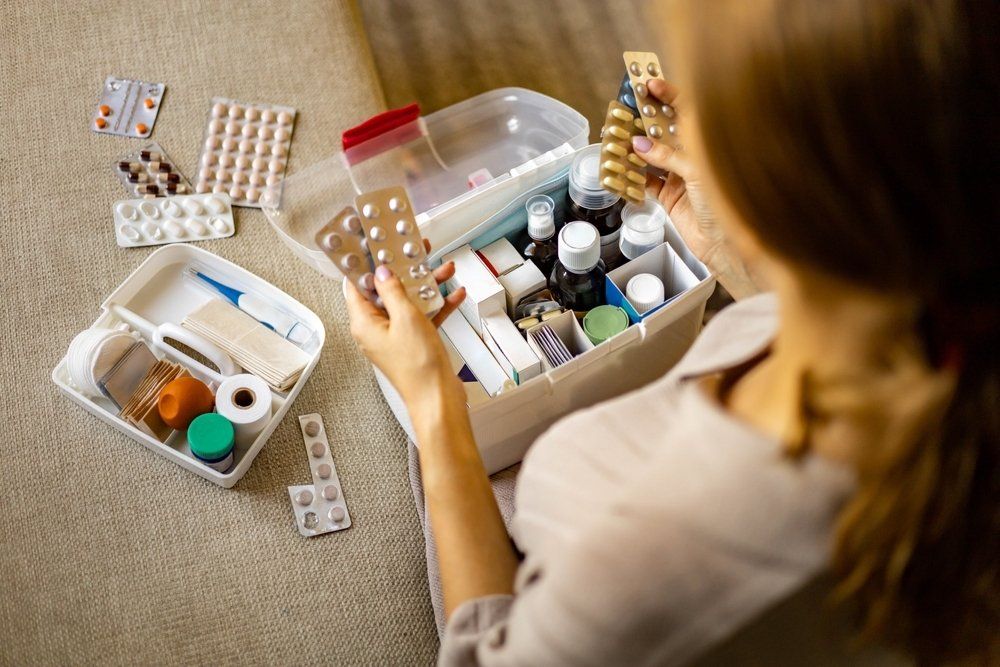Female Placing Medicament At Domestic First Aid Kit — Revive Training in Alstonville, NSW
