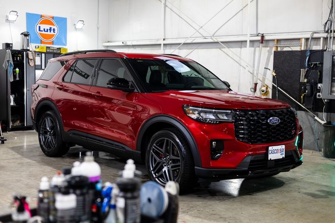 Red Ford Explorer SUV in a detail shop.