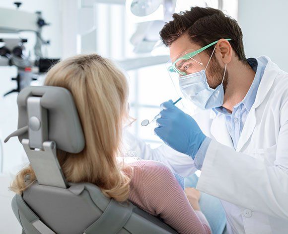 Dentist Checking Patient's Teeth — Haverhill, MA — Haverhill Dental Associates Inc Dentist Checking Patient's Teeth — Haverhill, MA — Haverhill Dental Associates Inc