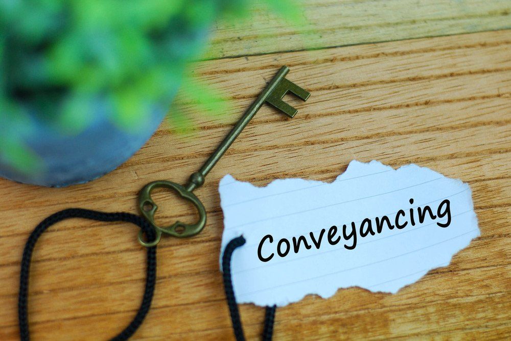 Key and Torn Paper with Text Conveyancing — Conveyancing in Gladstone, QLD