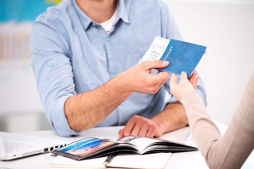 Young Man giving Tickets and Passport — Immigration Lawyer in Gladstone, QLD
