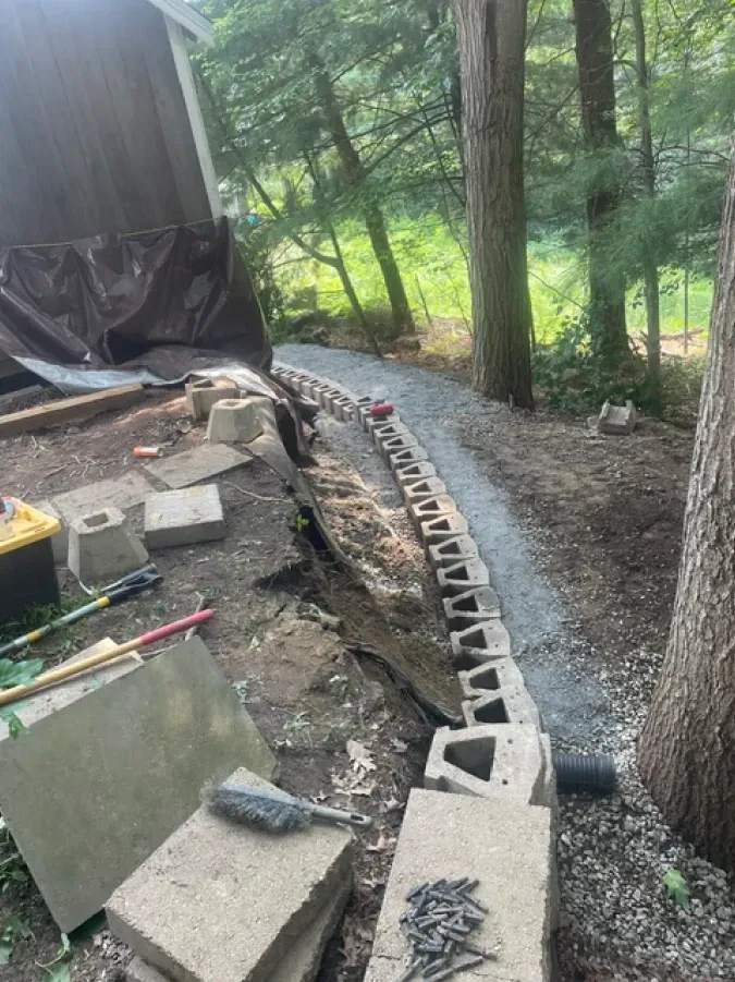 A concrete walkway is being built in the woods.