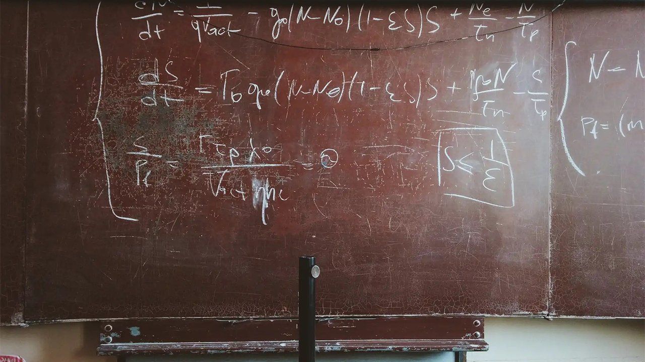A blackboard with a lot of math equations on it.