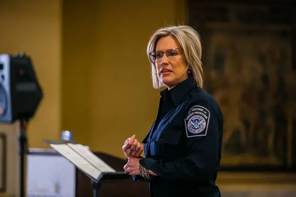 Lisa Marie Platske in uniform is standing at a podium giving a speech.