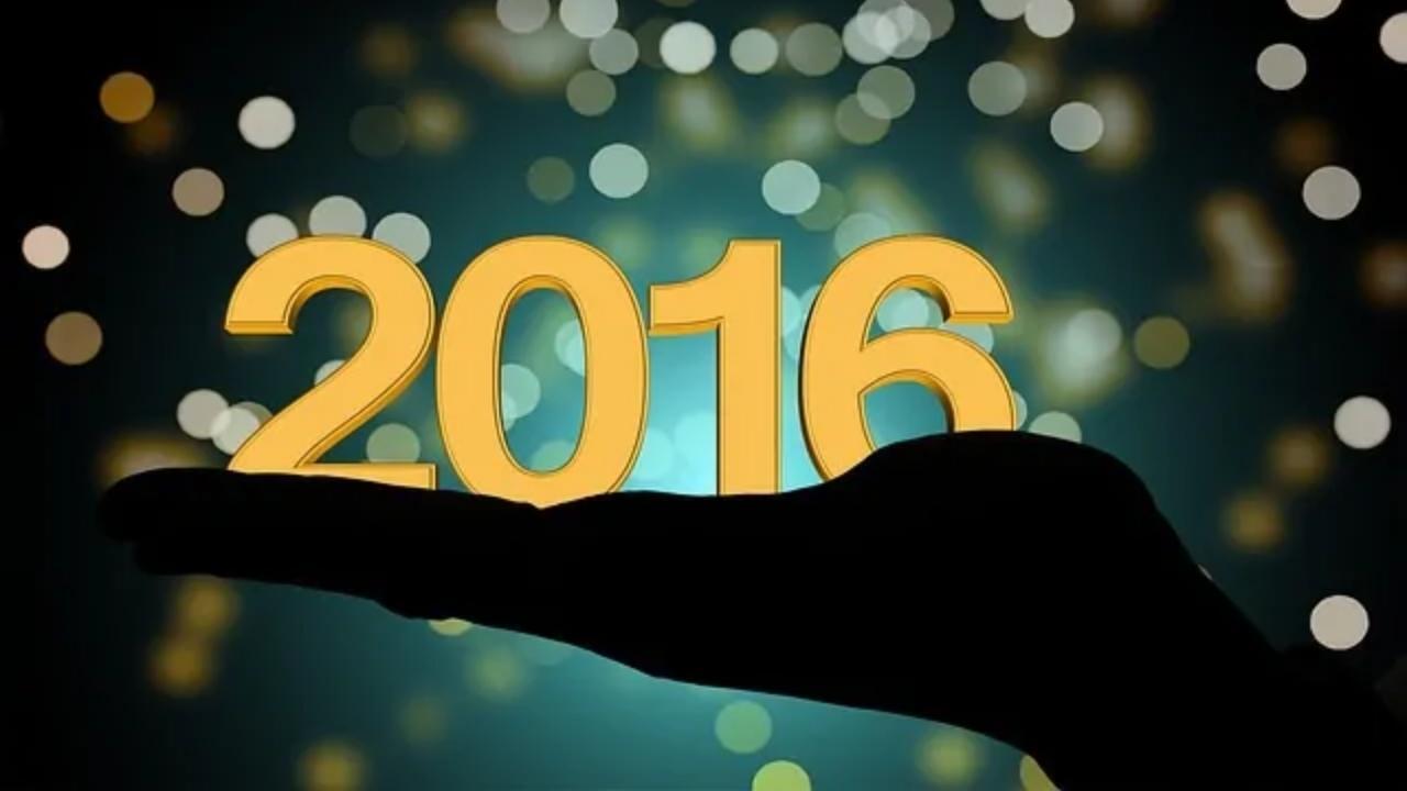 A silhouette of a hand holding the numbers 2016