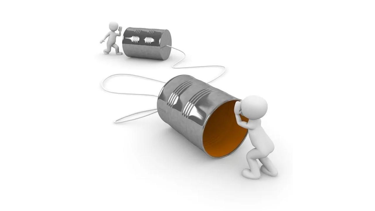 A man is pushing a tin can with a cord through it.