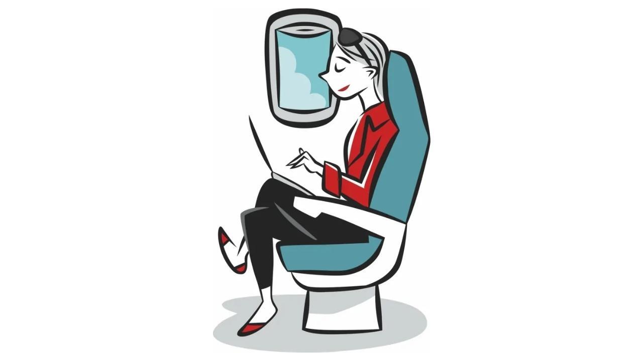 A woman is sitting on an airplane using a laptop computer.