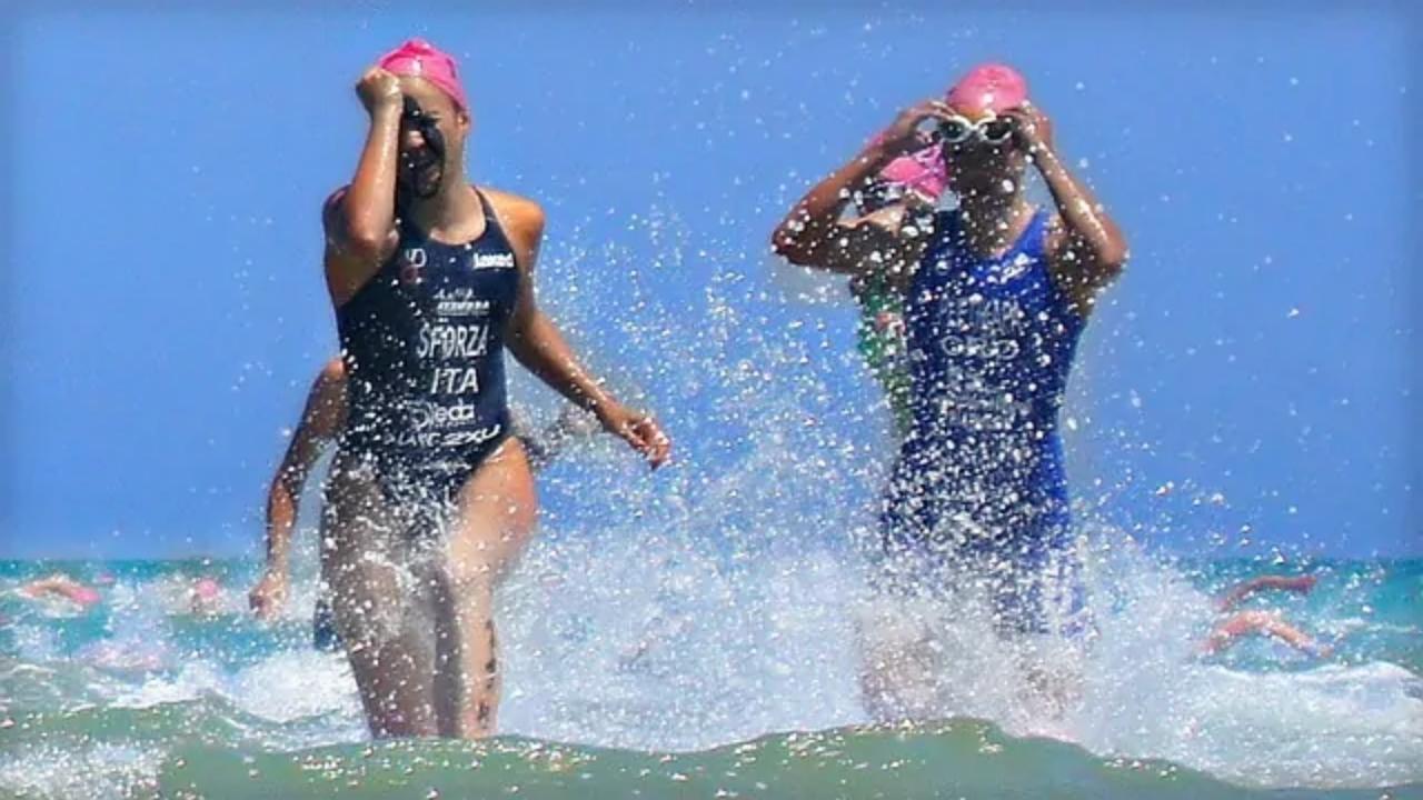 A group of people are swimming in the ocean.