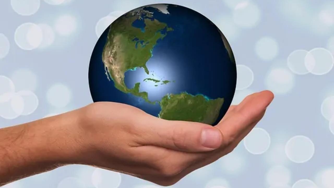A person is holding a globe in their hand.