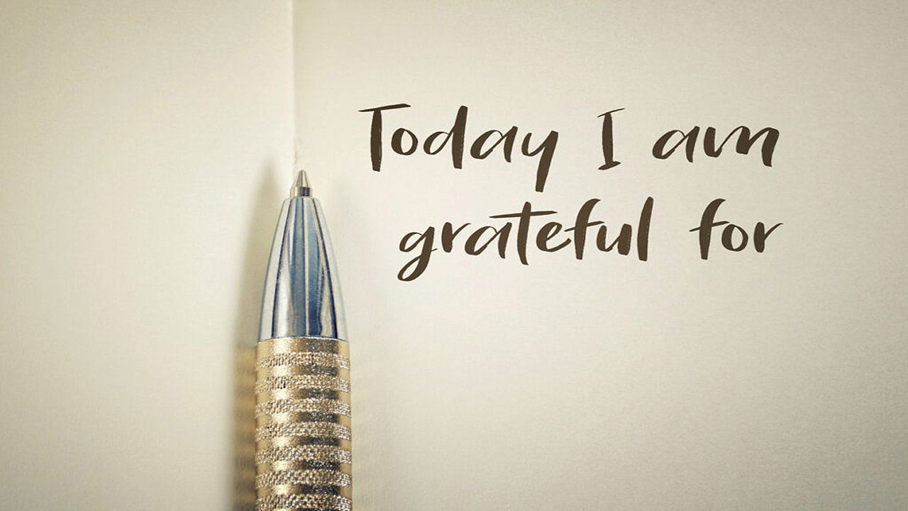 A pen is sitting on a piece of paper that says today i am grateful for.