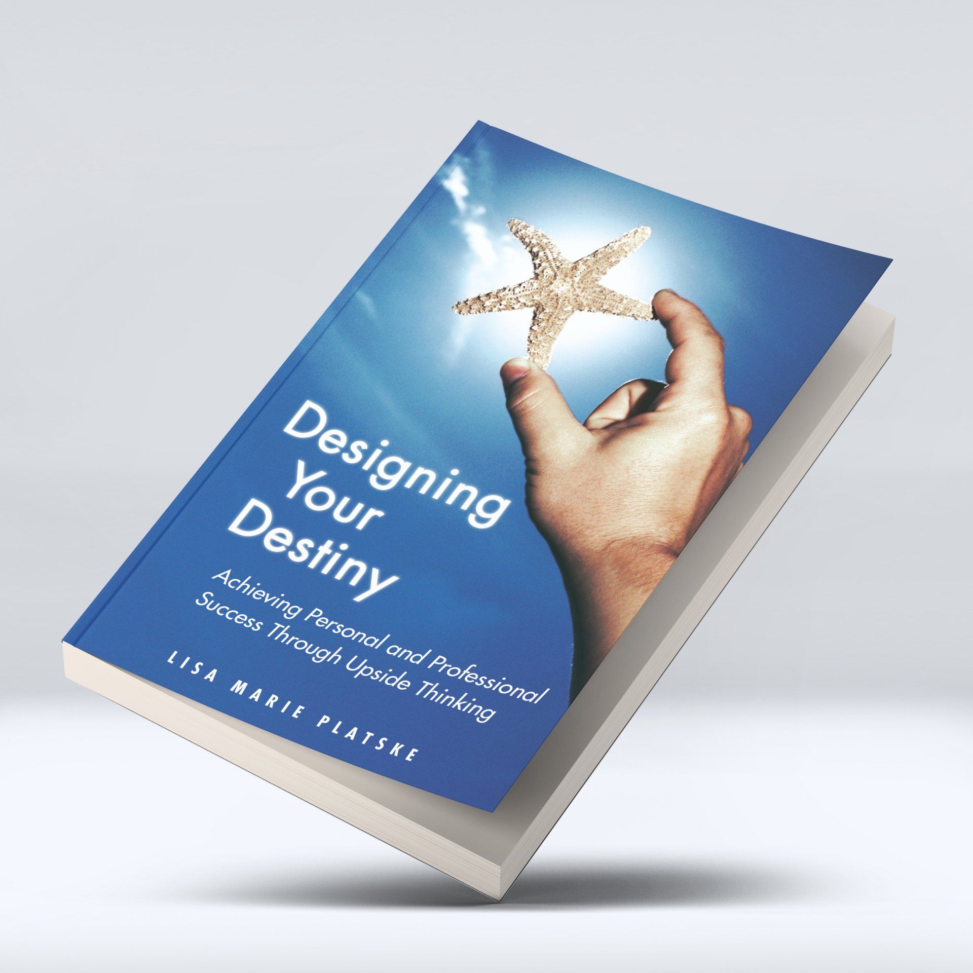 A book titled designing your destiny has a hand holding a starfish on the cover