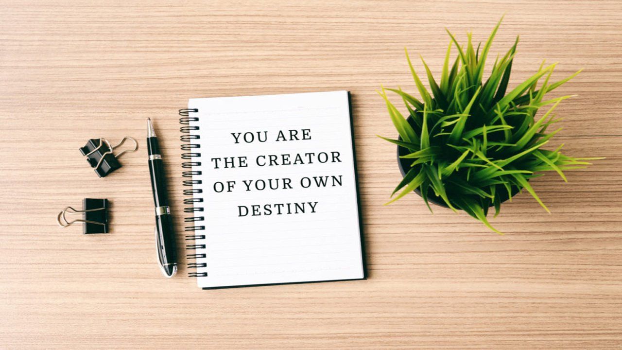 A notebook with the words `` you are the creator of your own destiny '' written on it