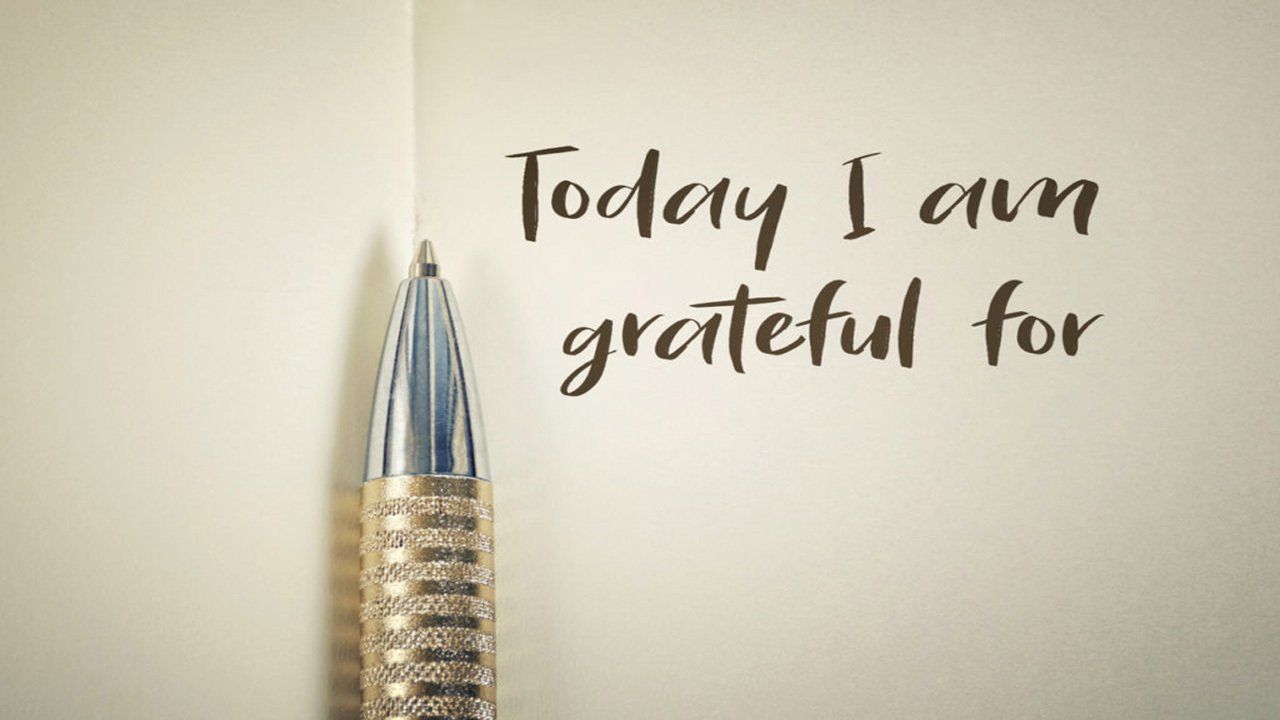 A pen is sitting next to a piece of paper that says today i am grateful for.