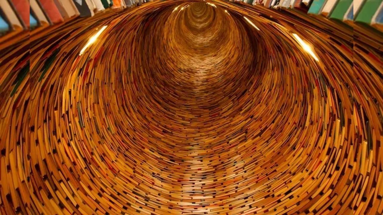 A tunnel filled with lots of books in a library.