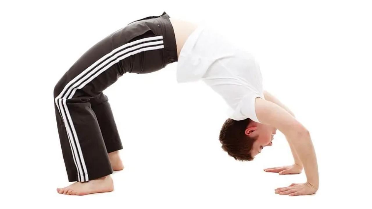 A person is doing a yoga pose on a white background.
