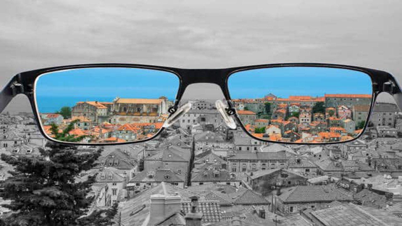 A pair of glasses with a reflection of a city in the lenses.