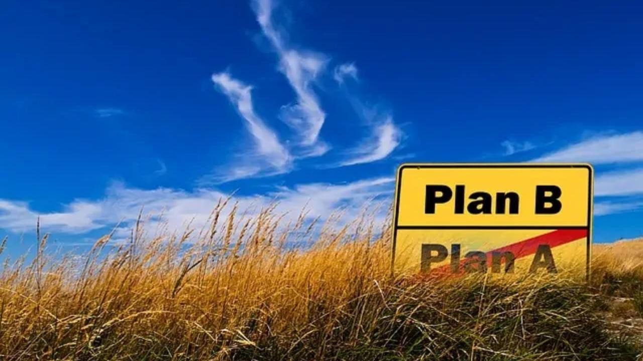 A sign in a field that says plan b and plan a