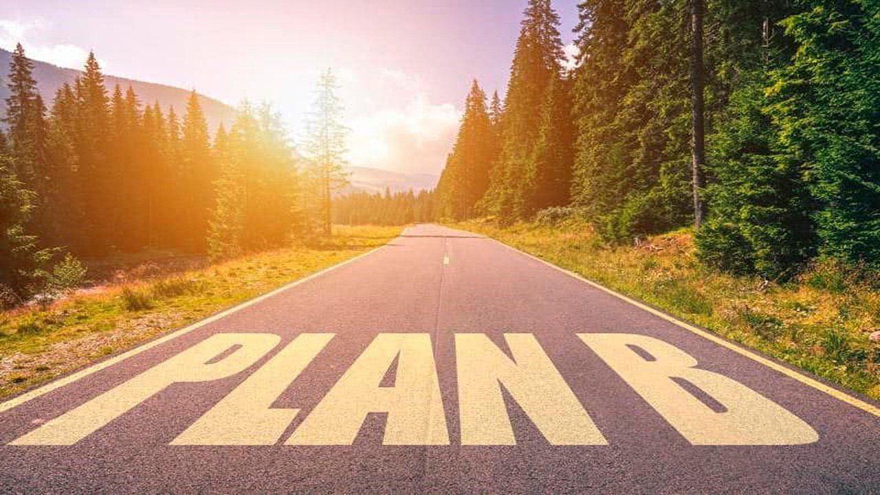 The word plan b is painted on the side of a road.