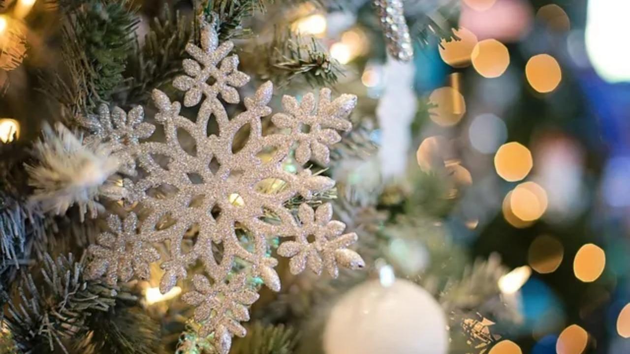 A close up of a snowflake on a christmas tree.