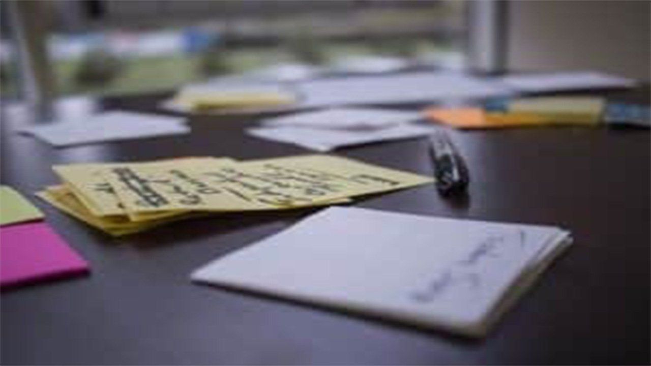 A table with sticky notes and a pen on it.