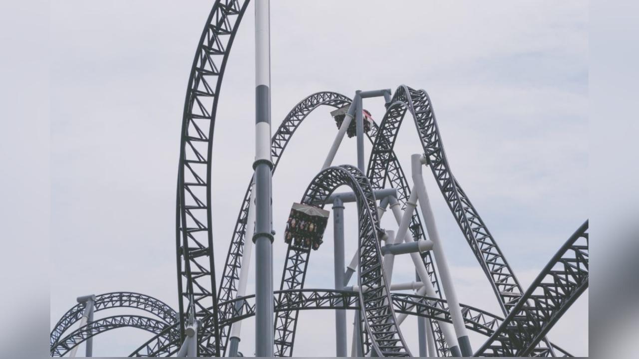 A roller coaster at an amusement park with a cloudy sky in the background