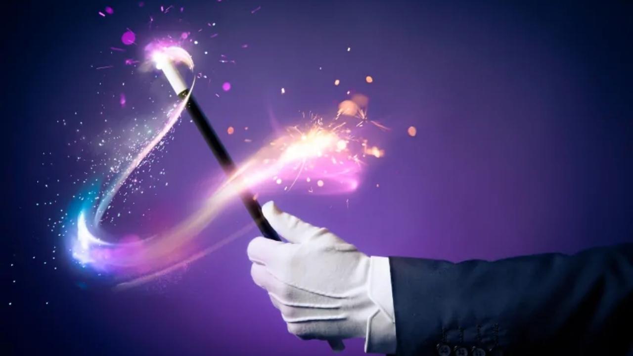 A close up of a person holding a magic wand.