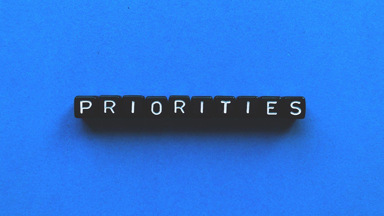 The word priorities is written in black blocks on a blue background.
