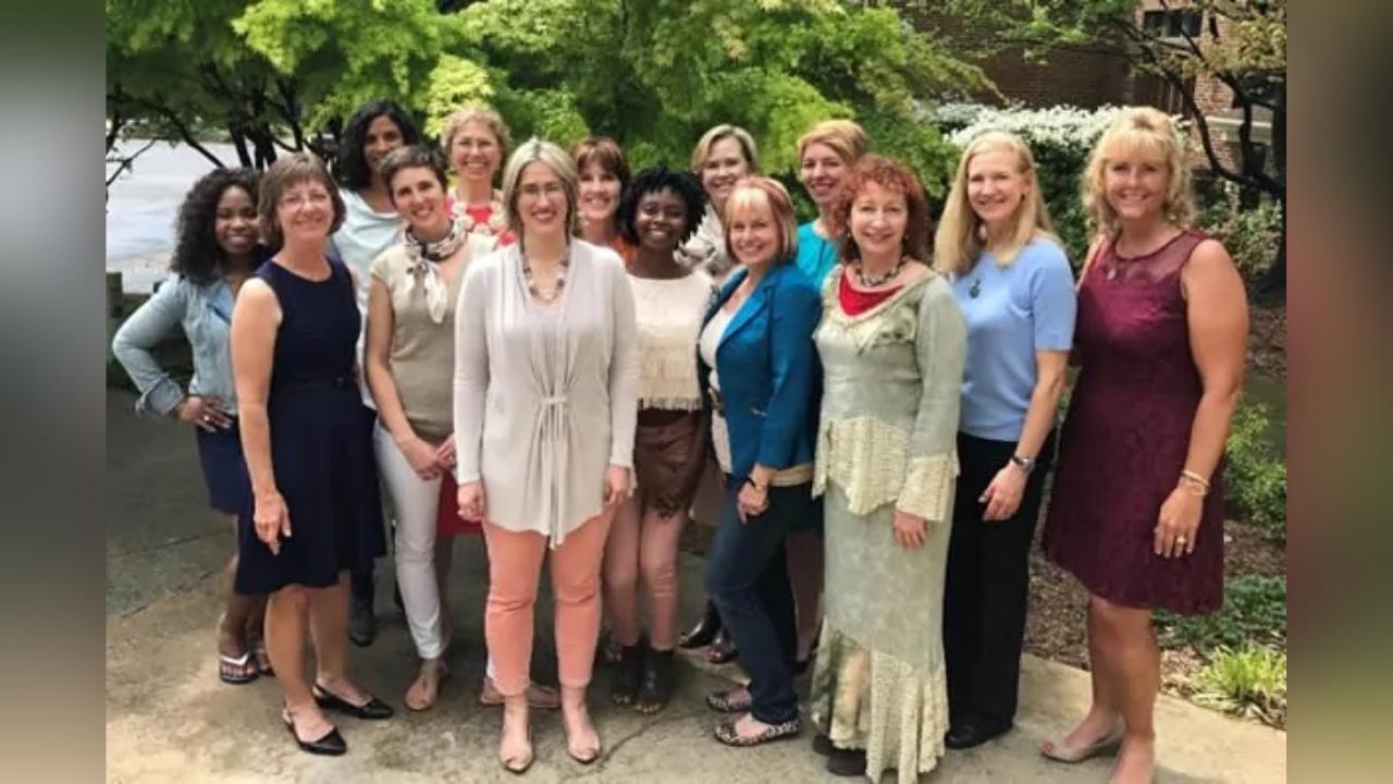 A group of women are posing for a picture together.