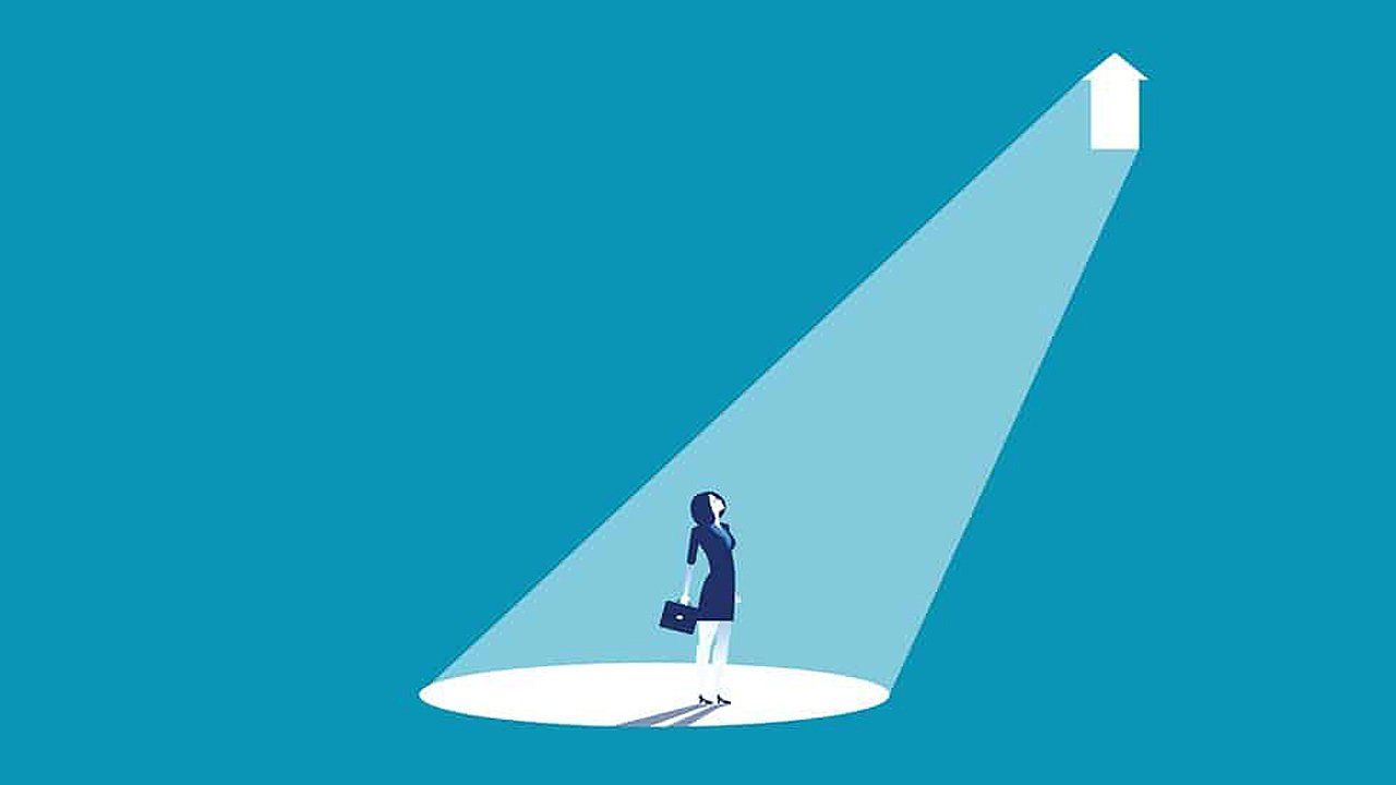 A woman is standing in a spotlight with an arrow pointing up.