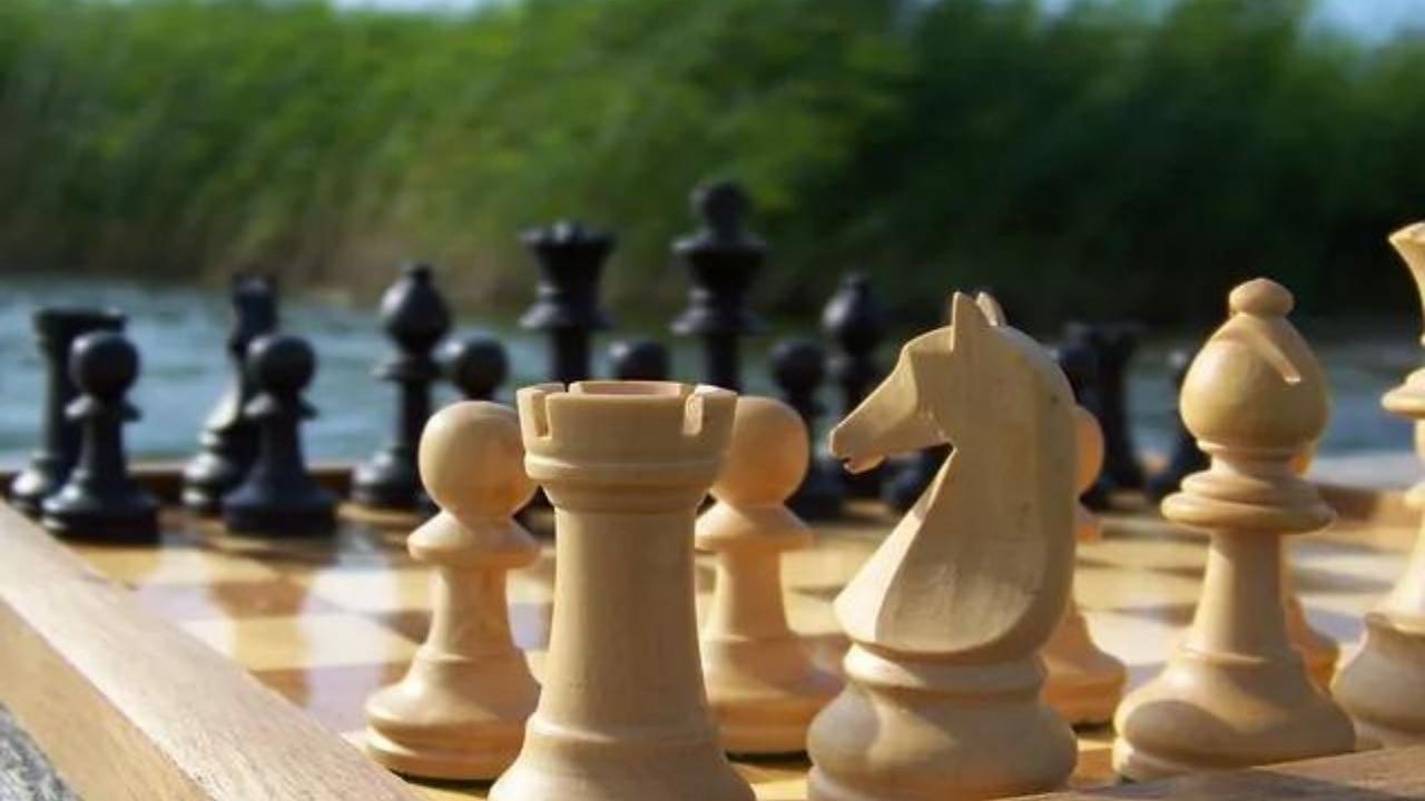 A close up of a chess board with pieces on it