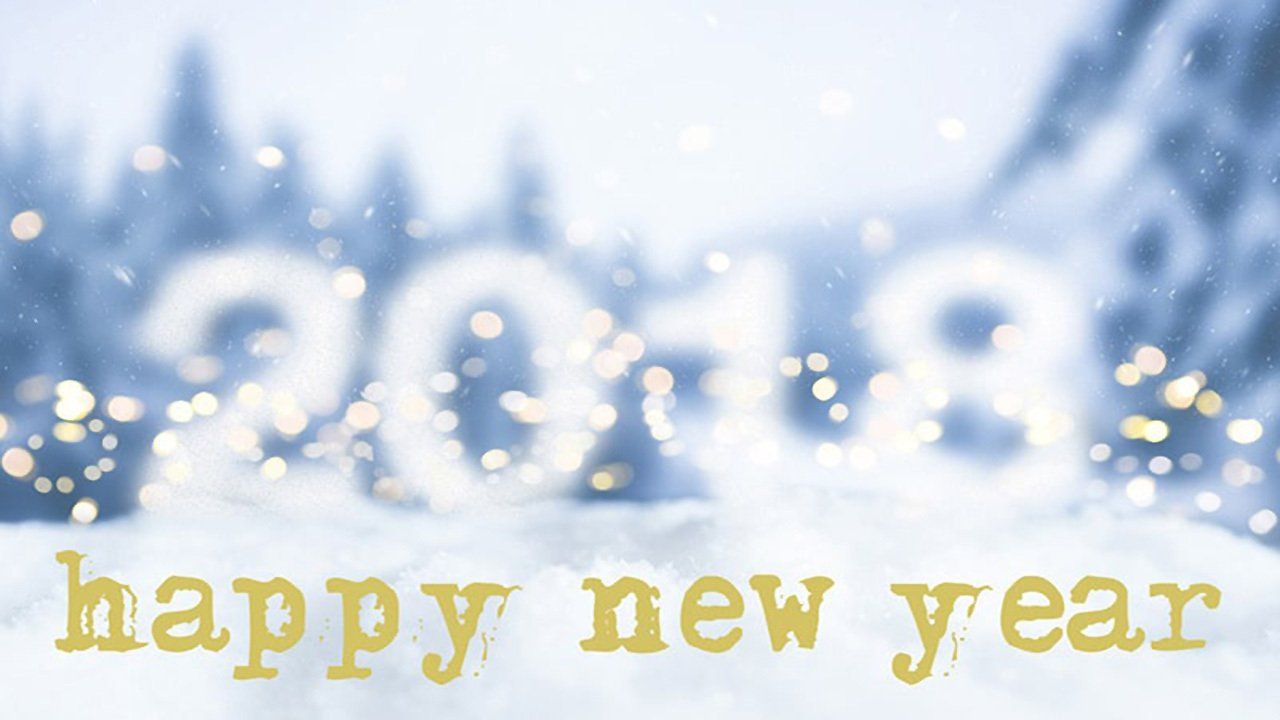 The word happy new year is written in the snow.
