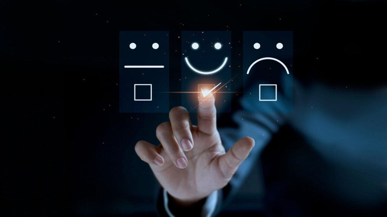 A person is pressing a button with a smiley face on it.
