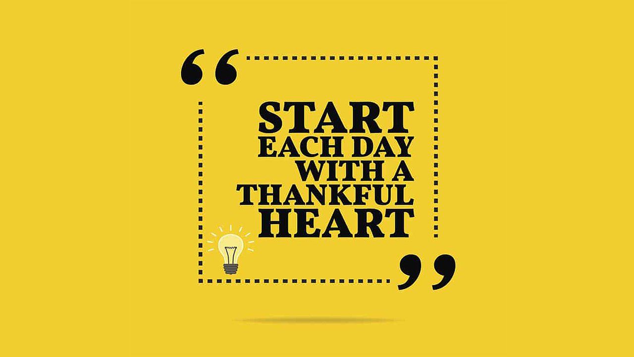 A yellow background with a quote that says `` start each day with a thankful heart ''