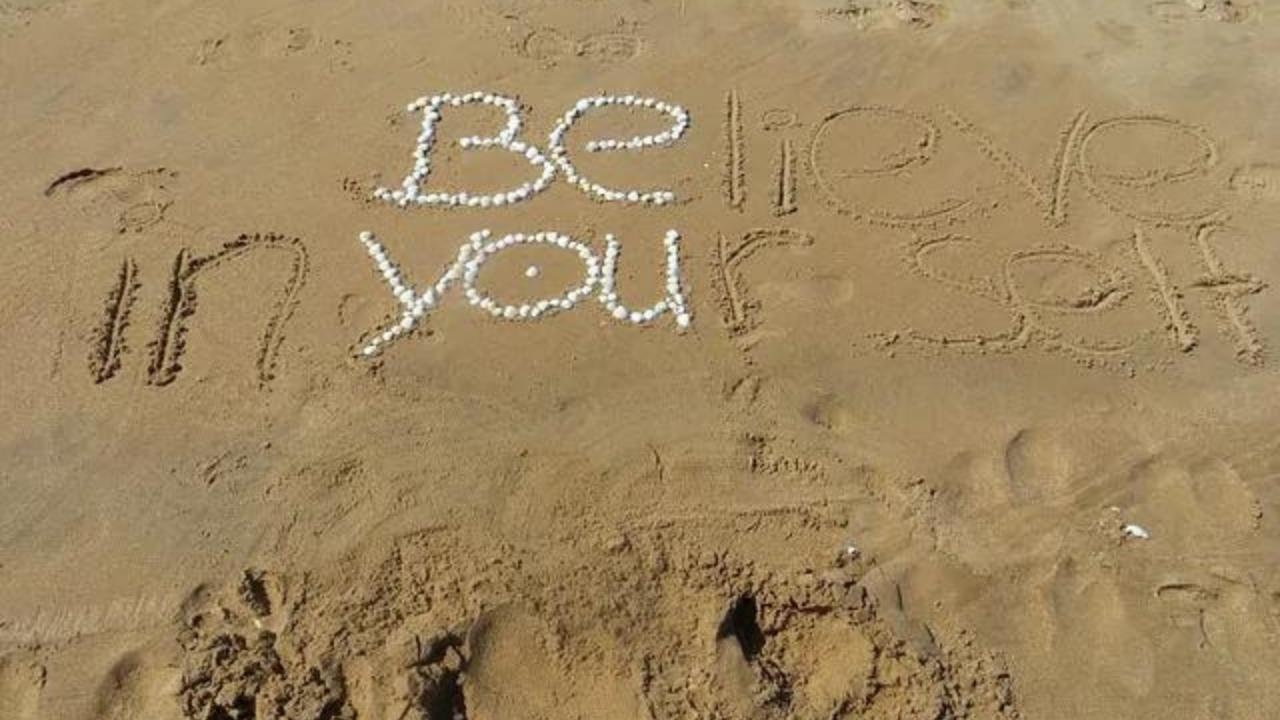 The word be is written in the sand on the beach.