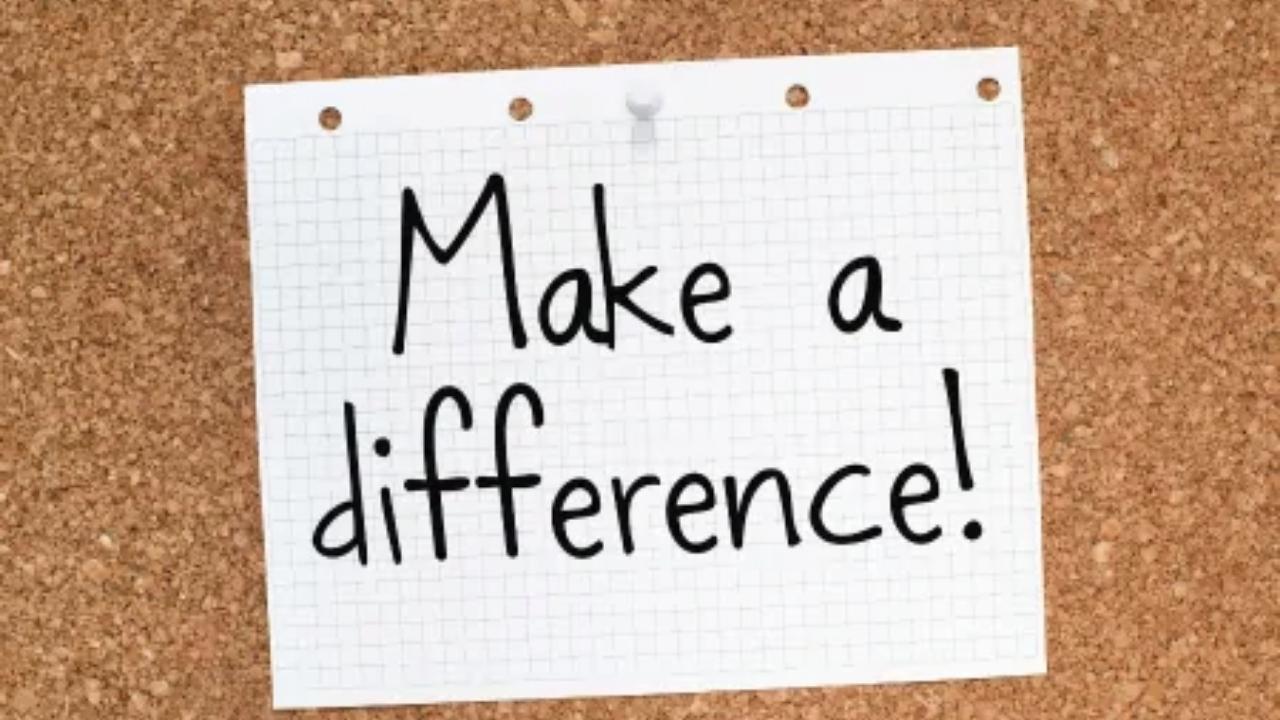 A note on a cork board that says make a difference