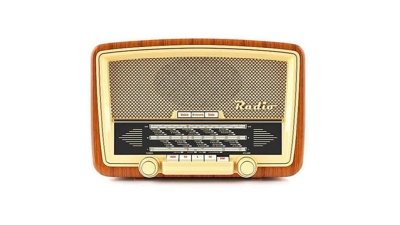An old radio with a wooden frame on a white background.