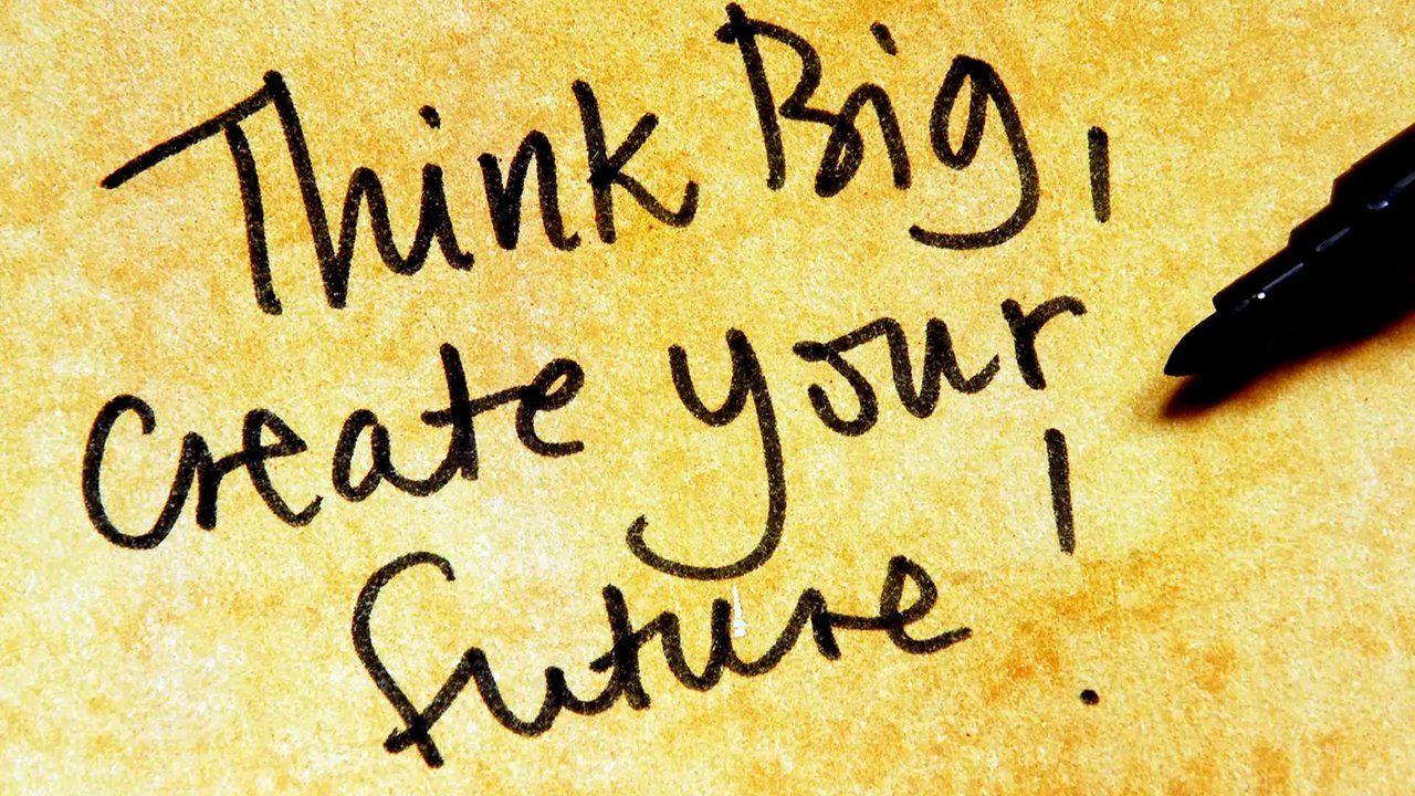 A piece of paper with the words think big create your future written on it