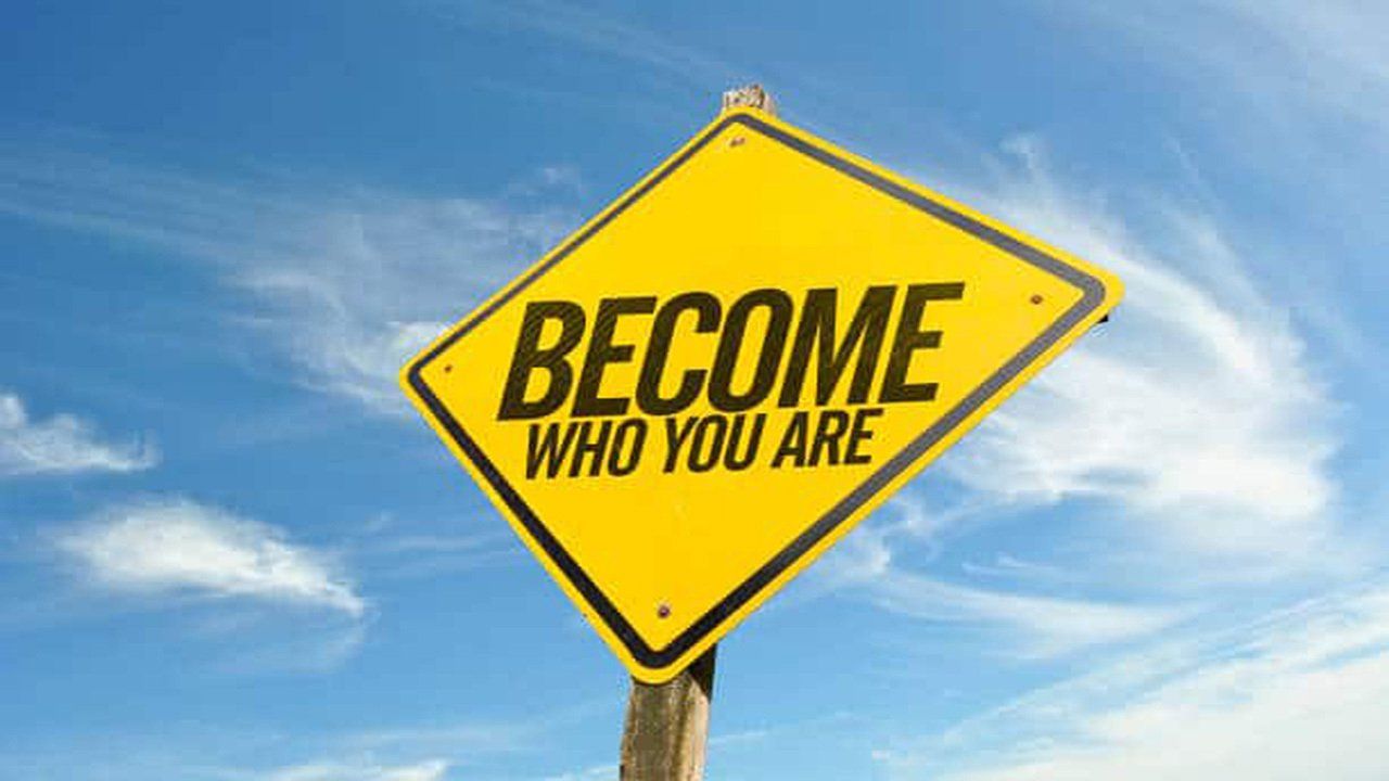 A yellow sign that says become who you are